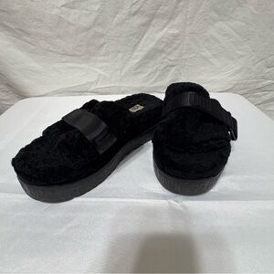 UGG Fluffita black sheepskin platform slide slippers.